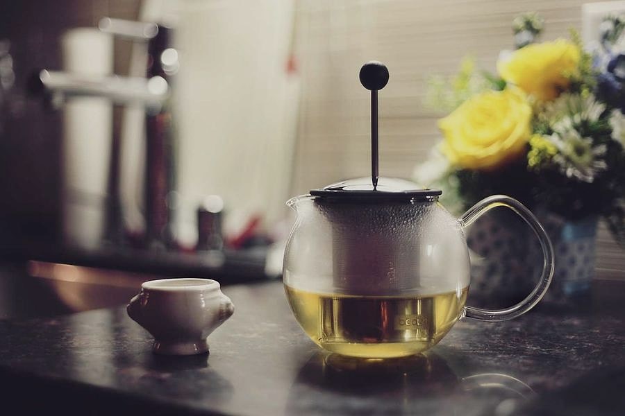 Kettle mid-boil on a dark kitchen counter